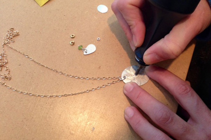Heather engraving a new necklace.